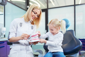 Child with dental assistant