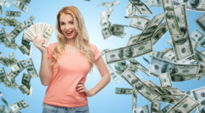 Young woman surrounded by money.