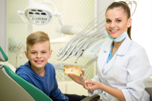 Pediatric dental assistant with patient